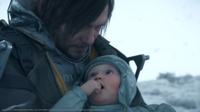 Death Stranding 2 game screenshot showing the protagonist cradling a baby