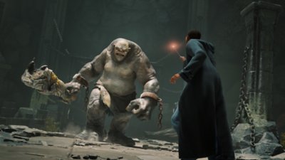 Istantanea della schermata del trailer di Hogwarts Legacy che mostra un mago puntare una bacchetta a un mostro gigante.