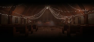 The Last of Us screenshot showing a church lift by festoon lights